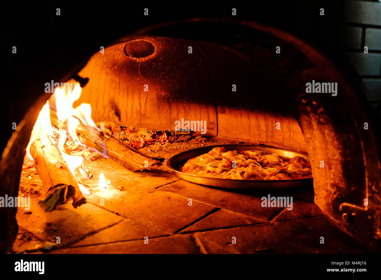 Hotbrick Cooking Brick oven with hot homemade pizza cooking inside Stock Photo - Alamy