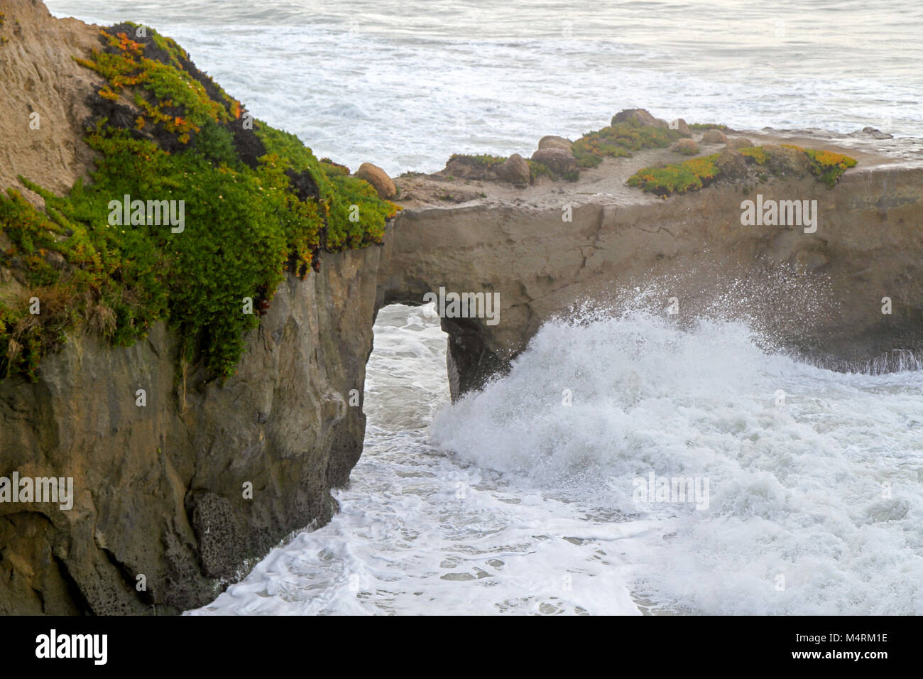 Waves break against cliffs, Santa Cruz, California, United States Stock Photo