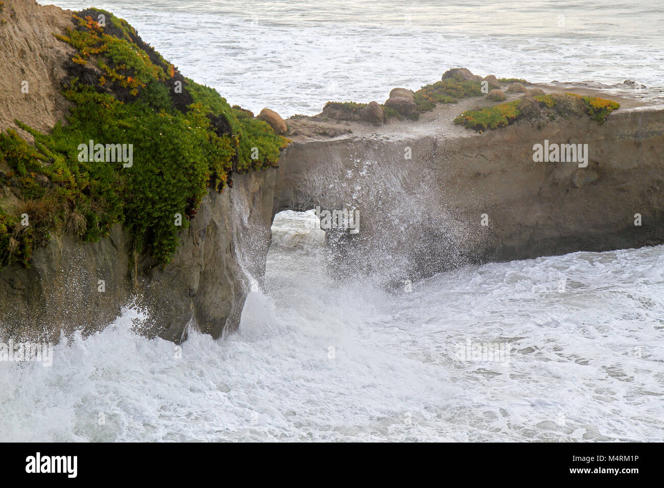 Waves break against cliffs, Santa Cruz, California, United States Stock Photo