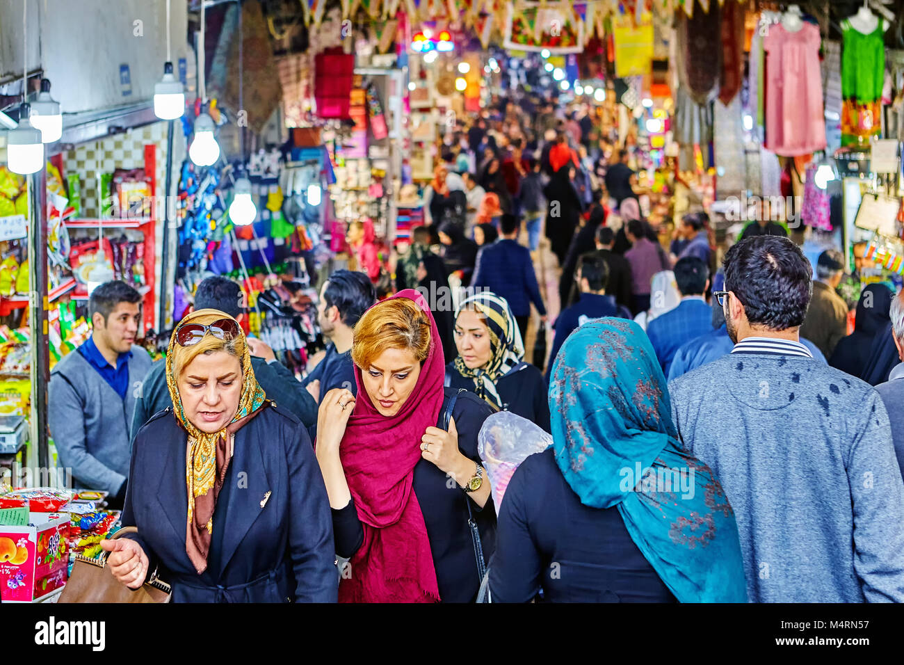 Tehran, Iran - April 29, 2017: Iranian women in hijabs are walking around big bazaar. Stock Photo