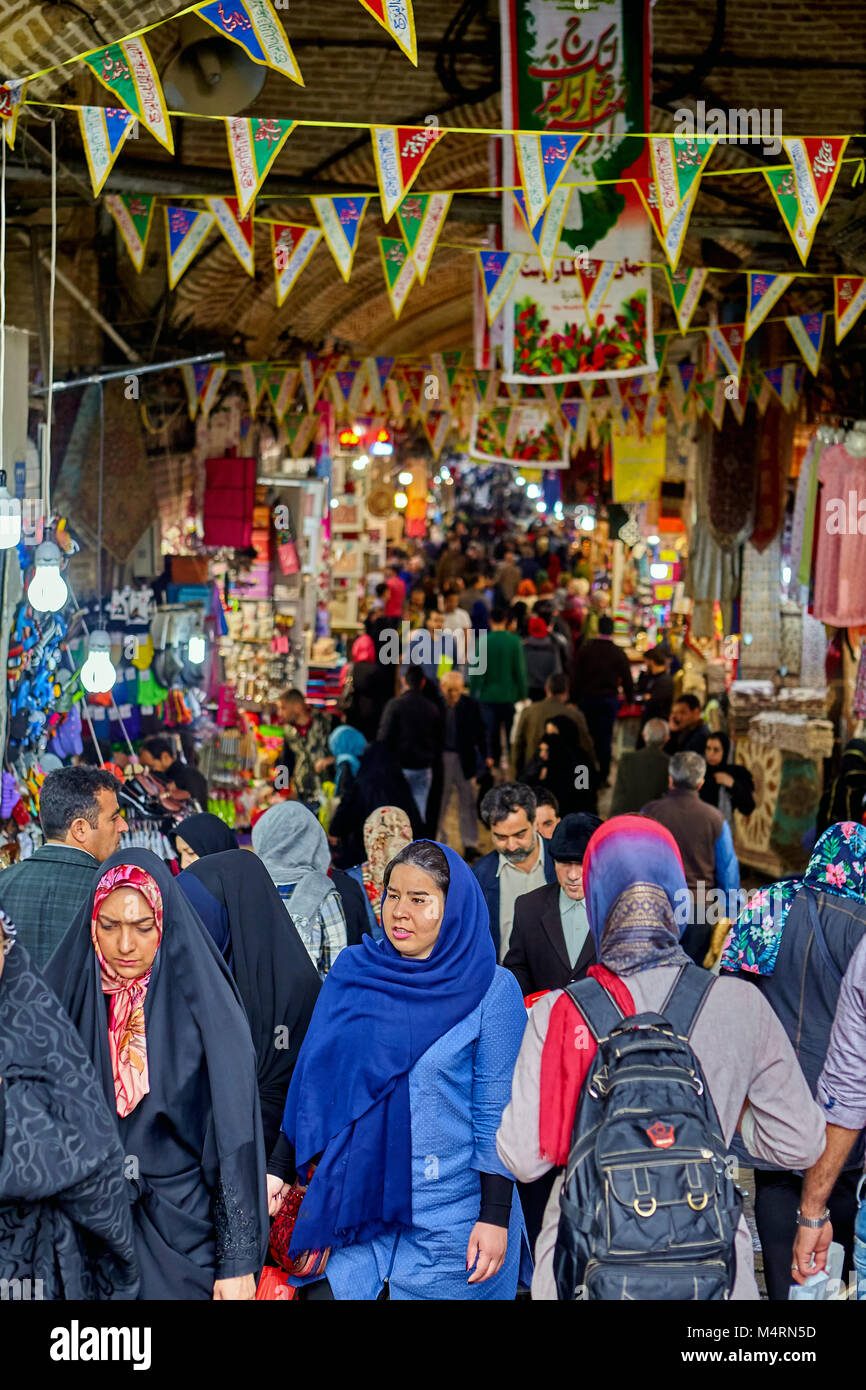 Tehran, Iran - April 29, 2017: Iranian men and women in hijabs walk around the big bazaar. Stock Photo