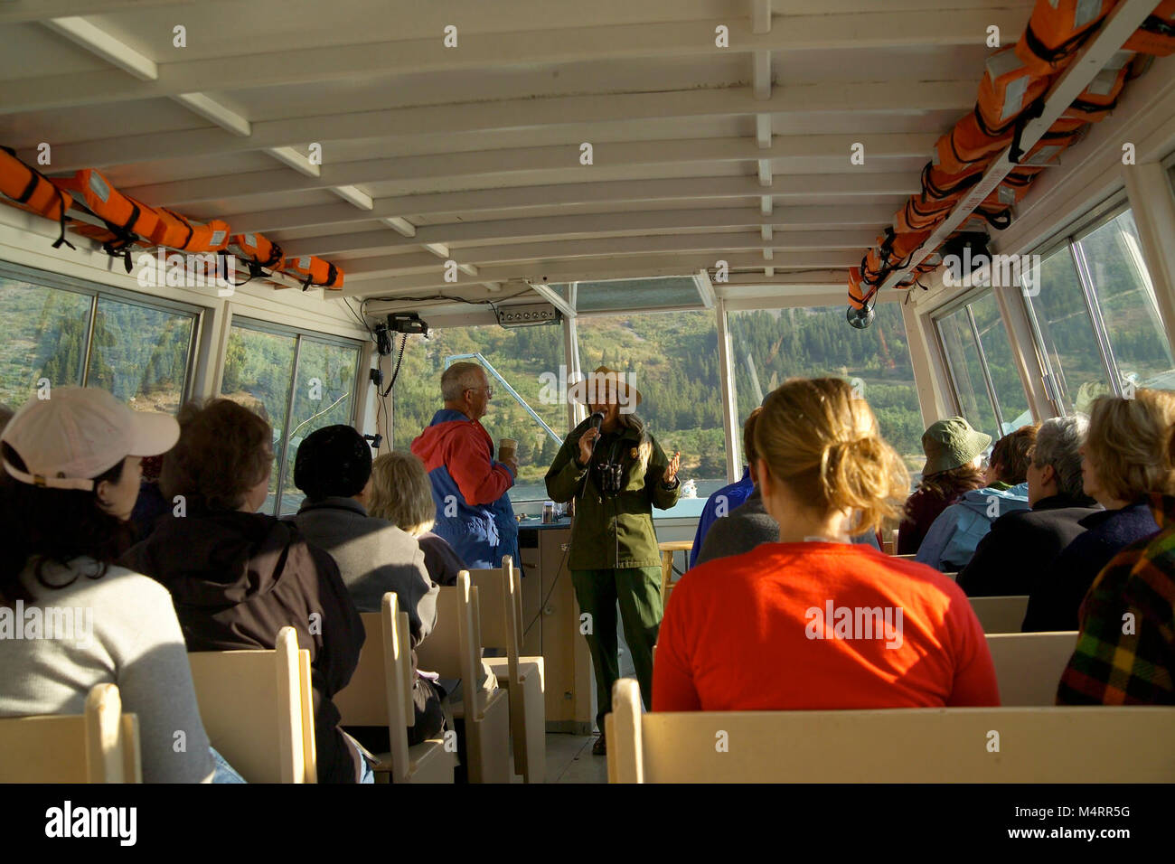 Park Ranger on a Boat Tour in Many Glacier..Park Ranger on a Boat Tour. Stock Photo