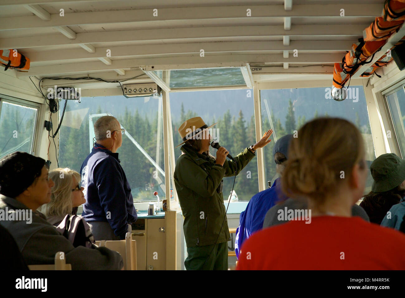 Park Ranger on a Boat Tour in Many Glacier..Park Ranger on a Boat Tour. Stock Photo