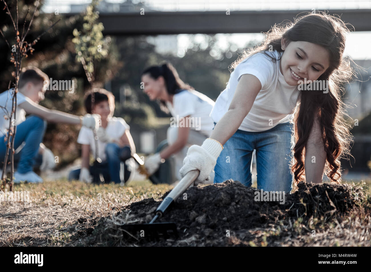 Nice pretty girl holding a rake Stock Photo - Alamy