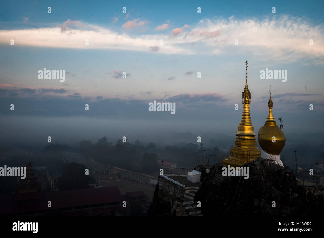 Taung Kwe Zedi misty sunrise Loikaw Myanmar Stock Photo
