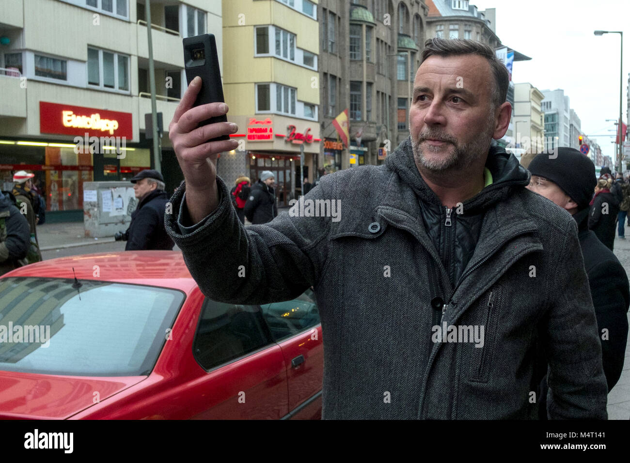 Berln, Germany. 17th Feb, 2018. Lutz Bachmann, founder of the anti-Islam movement 'Patriotische Europaeer gegen die Islamisierung Deutschlands' (lit. Patriotic Europeans Against the Islamisation of the West), films during a 'women's march' coming from the Alternative for Germany's (AfD) surrounding in Berln, Germany, 17 February 2018. More than 1000 people blocked the demonstration coming from the AfD background on Berlin's Friedrichstrasse. Credit: Stefan Jaitner/dpa/Alamy Live News Stock Photo