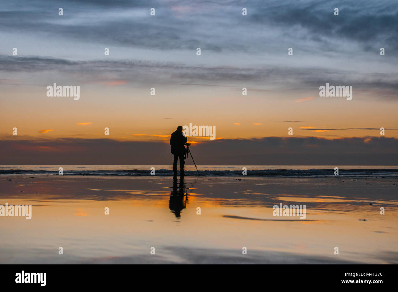 Birling Gap, East Sussex, UK . 17 February 2018..Sunset behind clouds creates spectacular colors & reflections  over the wet sand after another glorious Spring like day on the South Coast of England.. David Burr/Alamy Live News Stock Photo