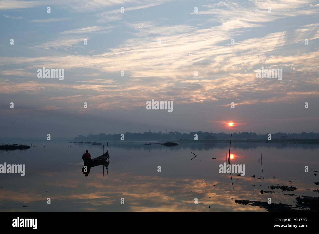 Mandalay, Myanmar. 18th February 2018. Fisherman at sunrise in Myanmar with beautiful sunrise. Credit: Carolyn Jenkins/Alamy Live News Stock Photo