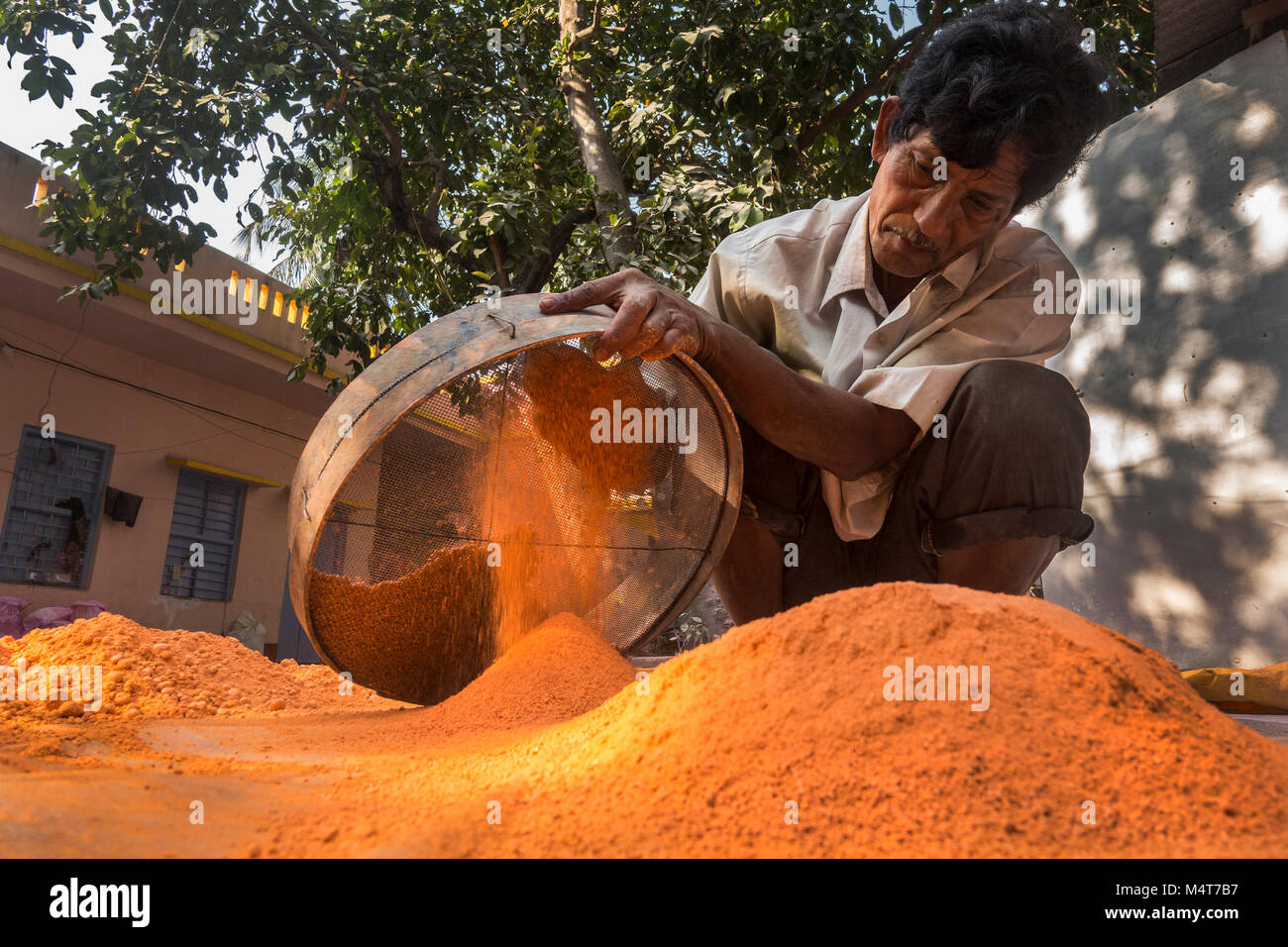 Kolkata, India. 17th Feb, 2018. An Indian man prepares gulal or colored powder, which will be used for the upcoming Holi Festival, at Uttar Chara village, some 110 km away from Kolkata, India, on Feb. 17, 2018. Holi Festival, also known as Spring Festival of Colors, usually falls in the later part of February or March, and it is celebrated by Hindu residents around the world by throwing gulal at each other. Credit: Tumpa Mondal/Xinhua/Alamy Live News Stock Photo