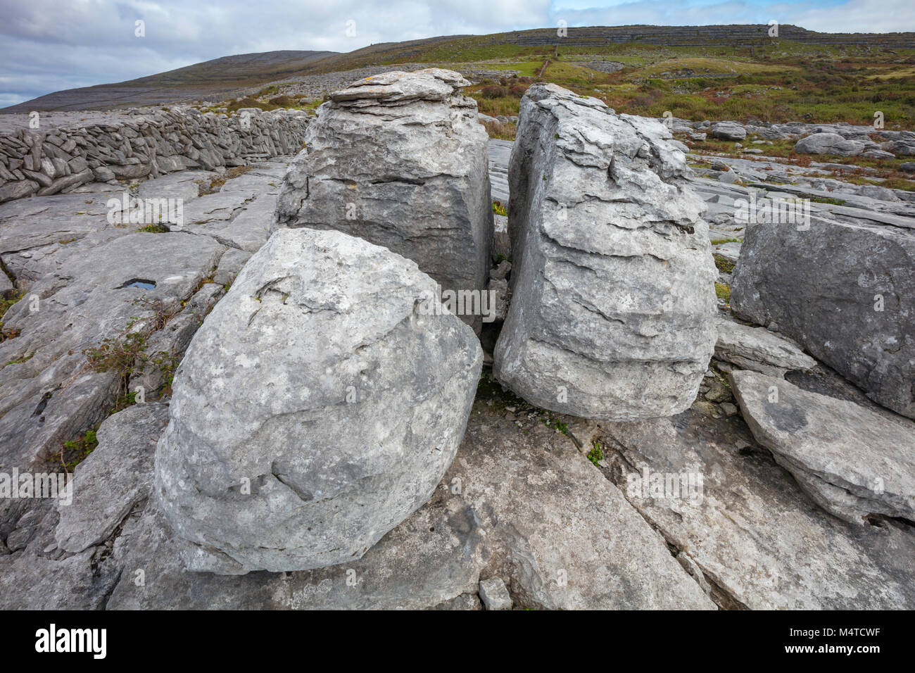 Limestone pavement and boulders in The Burren, County Clare, Ireland. Stock Photo