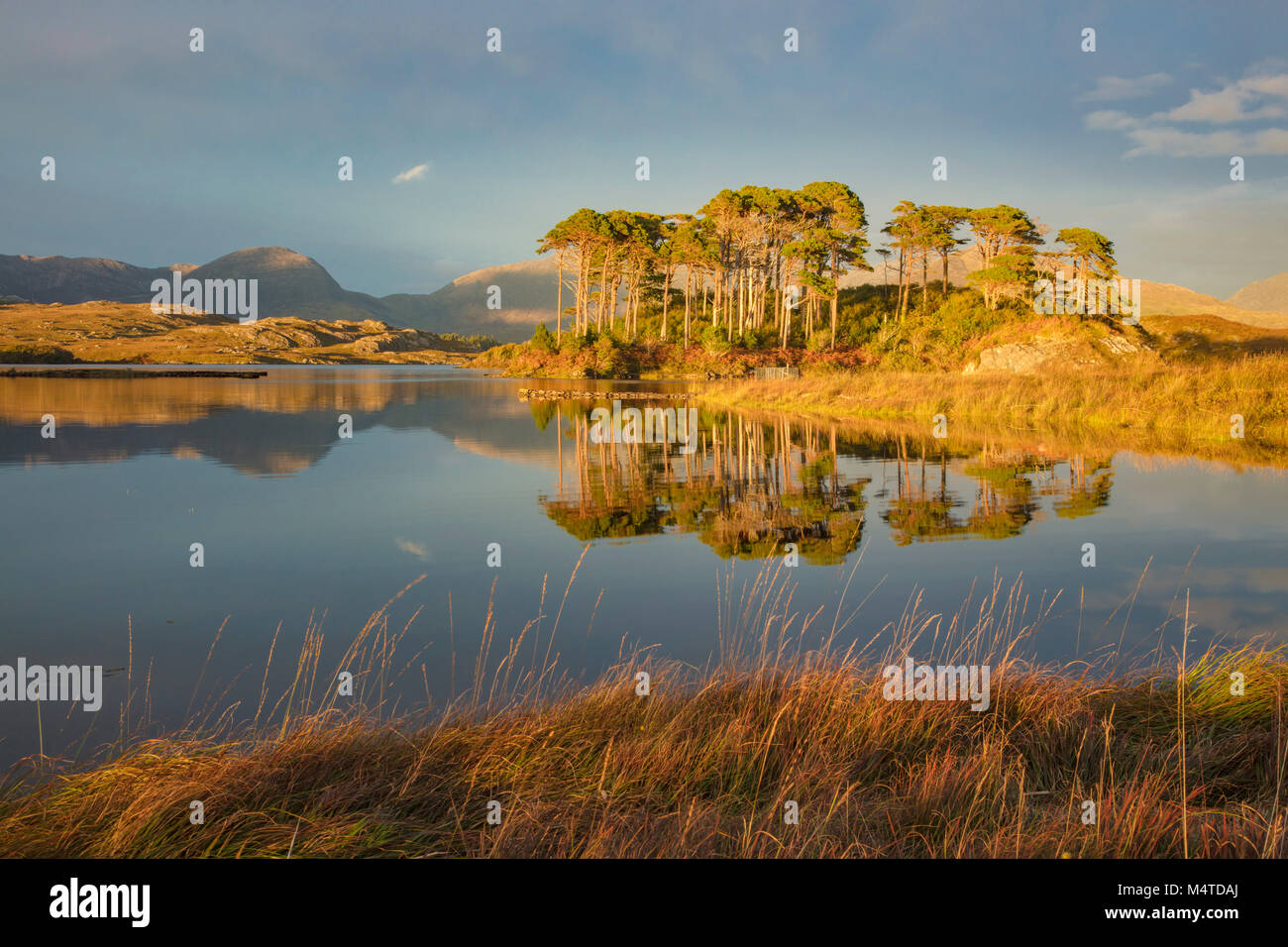 Sunset reflections in Derryclare Lough, Connemara, County Galway, Ireland. Stock Photo