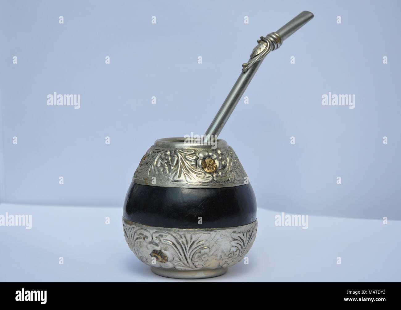 Elaborate chased metalwork mate tea gourd and bombilla from Argentina. Stock Photo