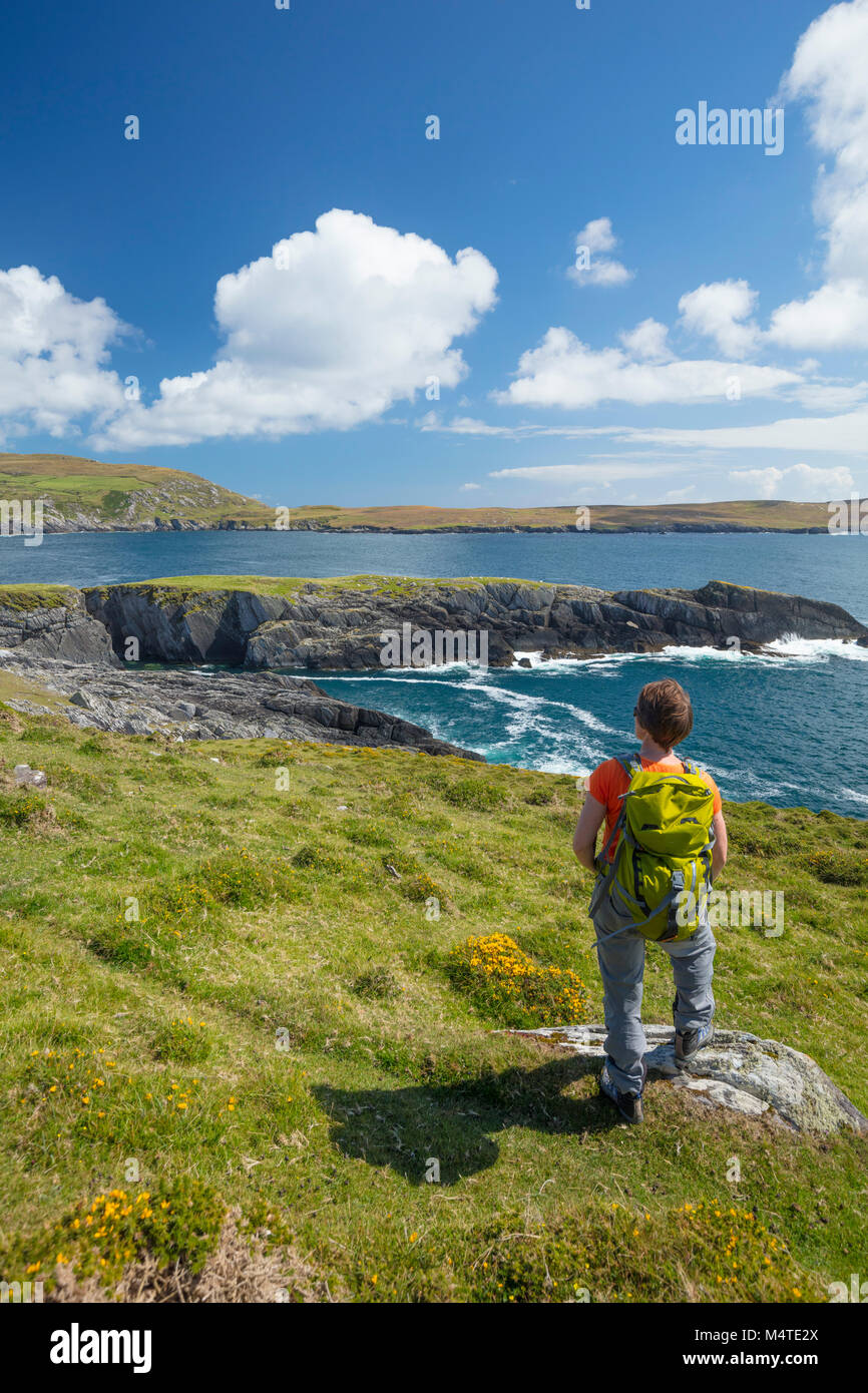 Hiker looking to Illanebeg islet, Dursey Island, Beara Peninsula, County Cork, Ireland. Stock Photo