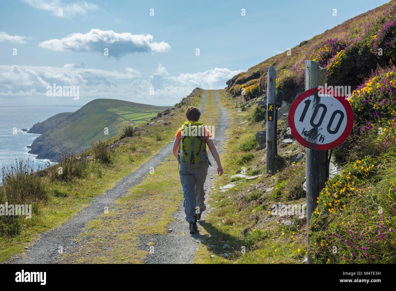 Hiker and quirky speed sign, Dursey Island, Beara Peninsula, County Cork, Ireland. Stock Photo