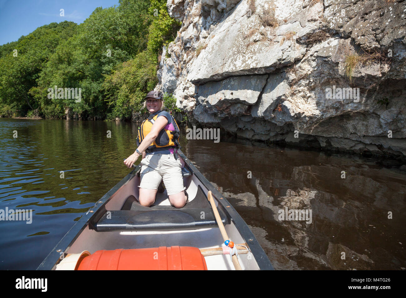 Canoeist beside a limestone outcrop, Blackwater River, Mallow, County Cork, Ireland. Stock Photo