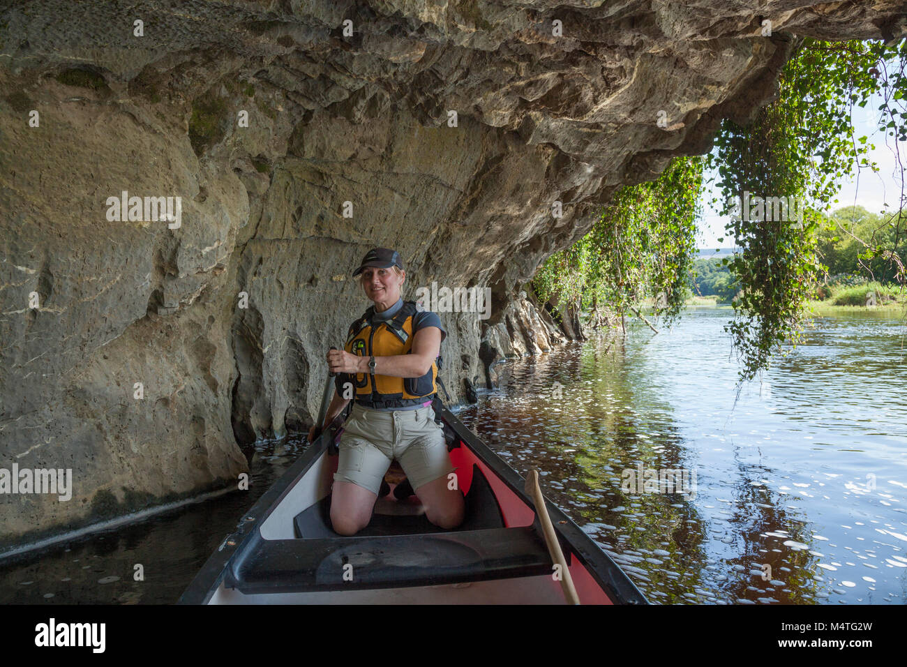 Canoeist beneath a limestone cliff, Blackwater River, Mallow, County