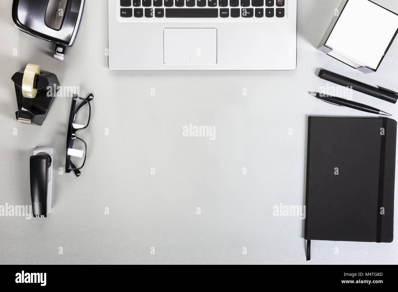 Elevated View Of A Desk With Laptop And Office Supplies Stock Photo