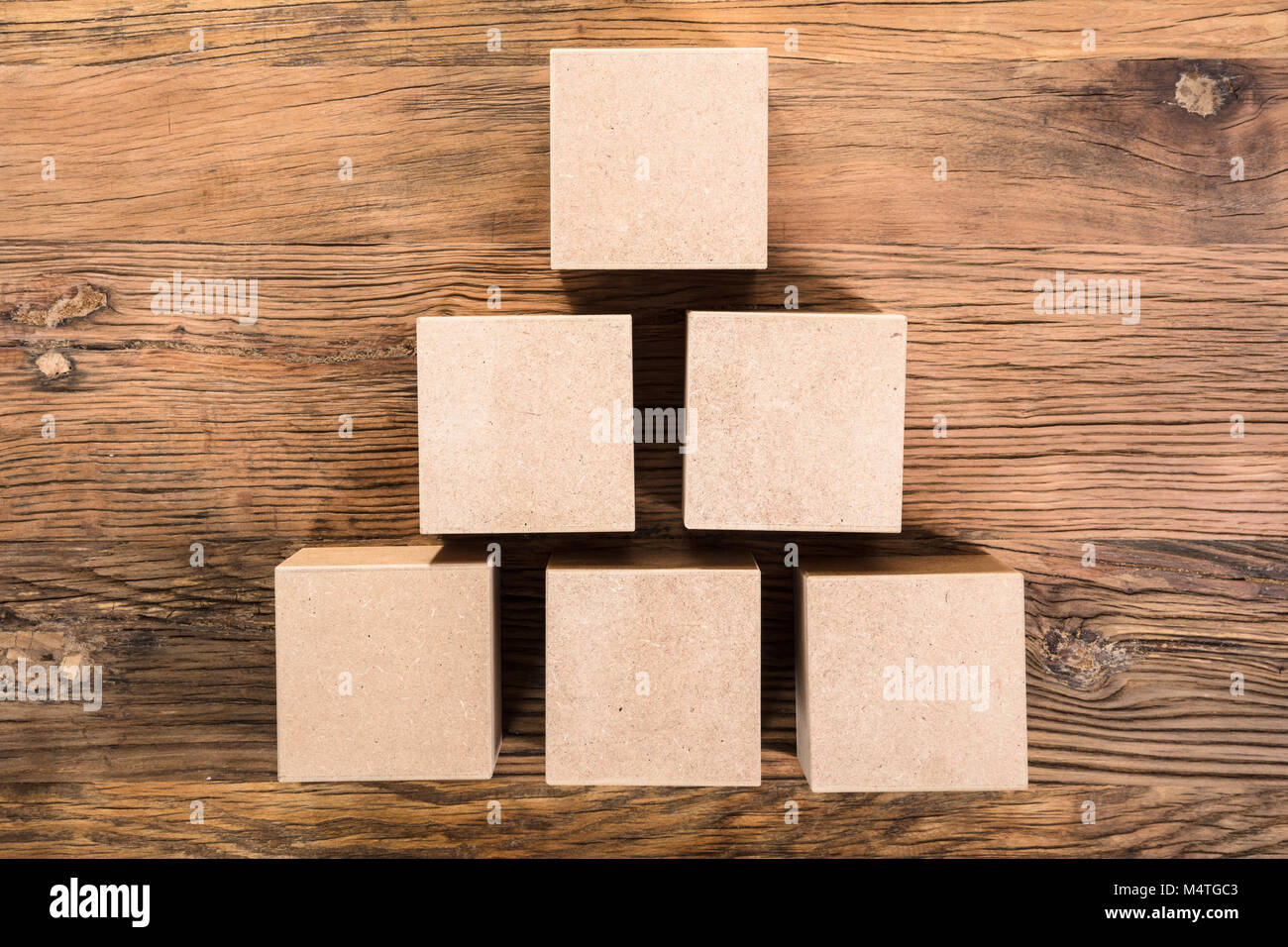 Elevated View Of Cube Arranged In Pyramid Shape Over The Wooden Table Stock Photo