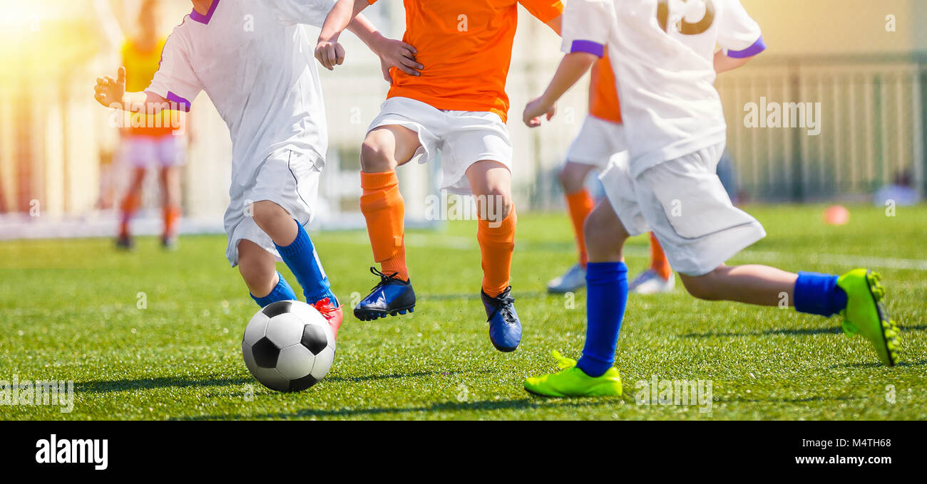Child Having Fun Playing Soccer Game. Youth Soccer Match for Kids. Outdoor Football Tournament on School Pitch. Young Footballlers Running the Ball Stock Photo
