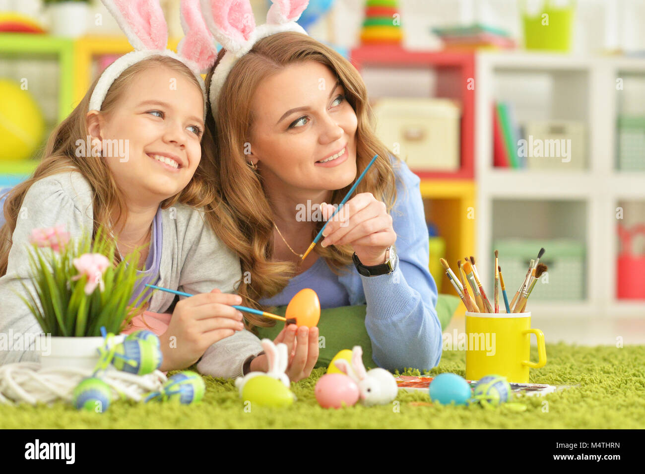 Mother and daughter colouring eggs  Stock Photo