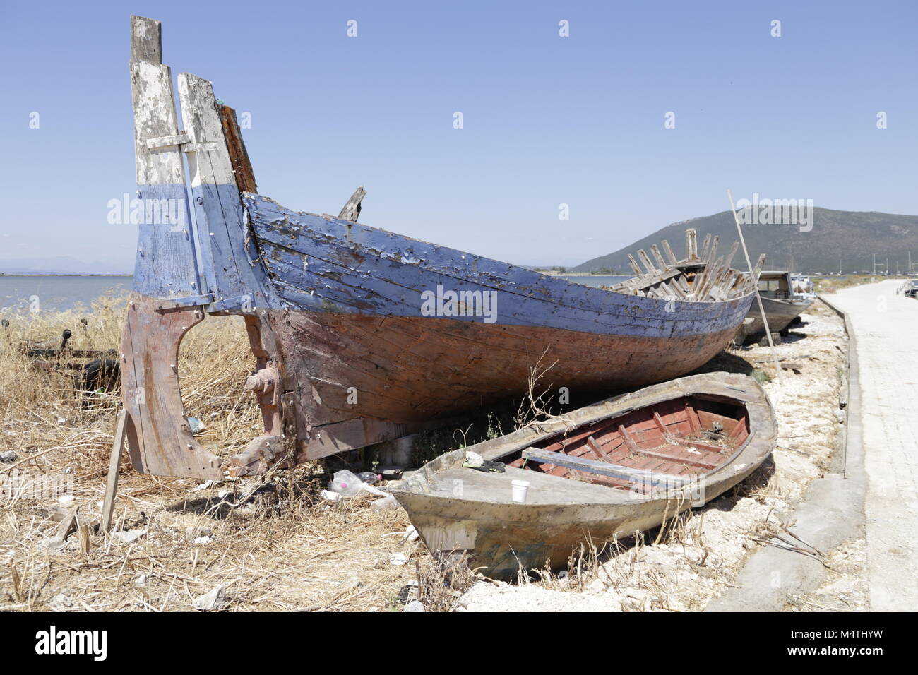 Old broken fishing boat on shore Stock Photo - Alamy