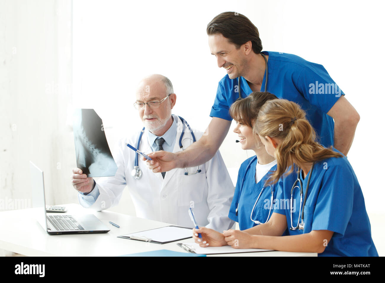 Medical team checking on X-ray results isolated on white Stock Photo ...