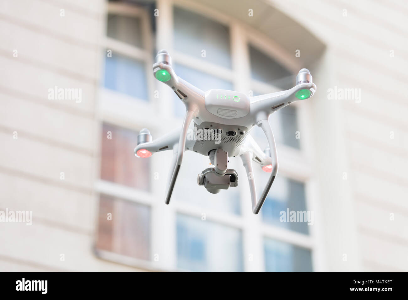 Low angle view of drone spying through house window Stock Photo