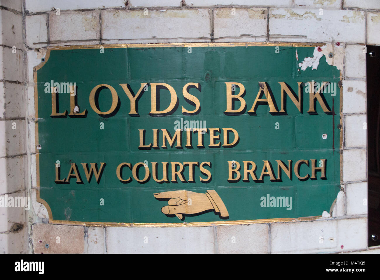 An old metal sign showing directions to Lloyds Bank Limited Law Courts Branch Stock Photo