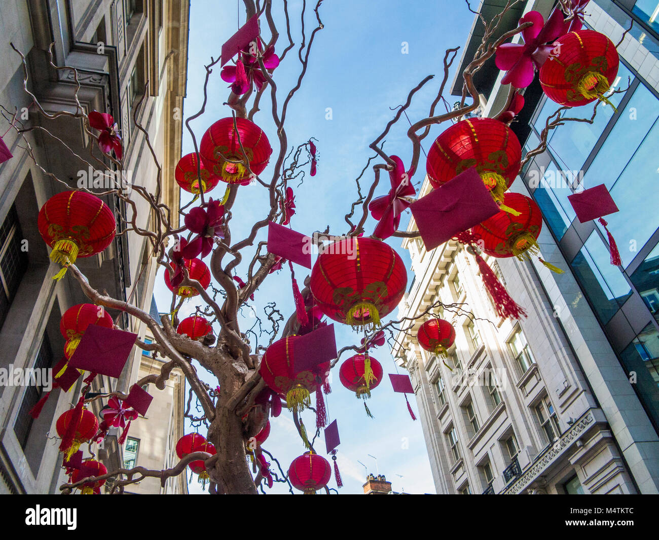 Chinese Lanterns on display in large bonsai style wishing tree in Regent Street with red envelopes for good luck Stock Photo