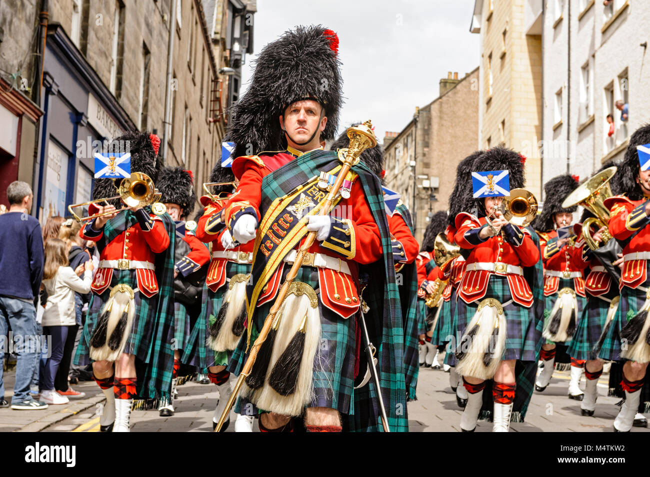 The Pipes and Drums of the Royal Regiment of Scotland lead the parade for the UK Armed Forces Day 2014 through the streets of Stirling, Scotland. Stock Photo
