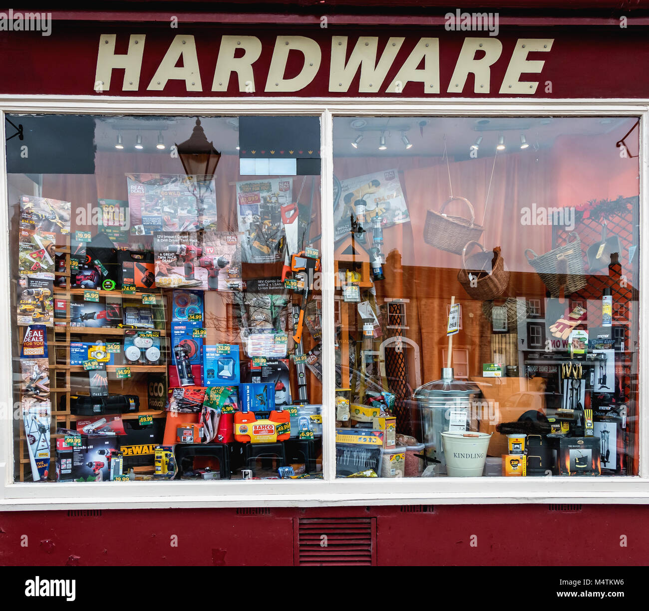 A hardware store shop window with a display of assorted tools ...