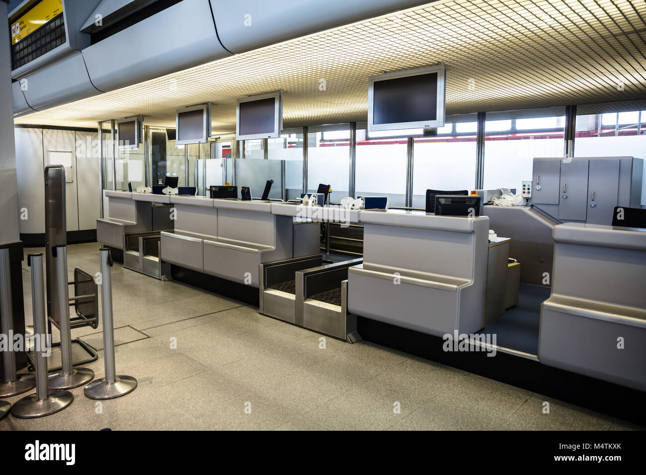Checkin area with monitors mounted on ceiling at modern airport Stock Photo
