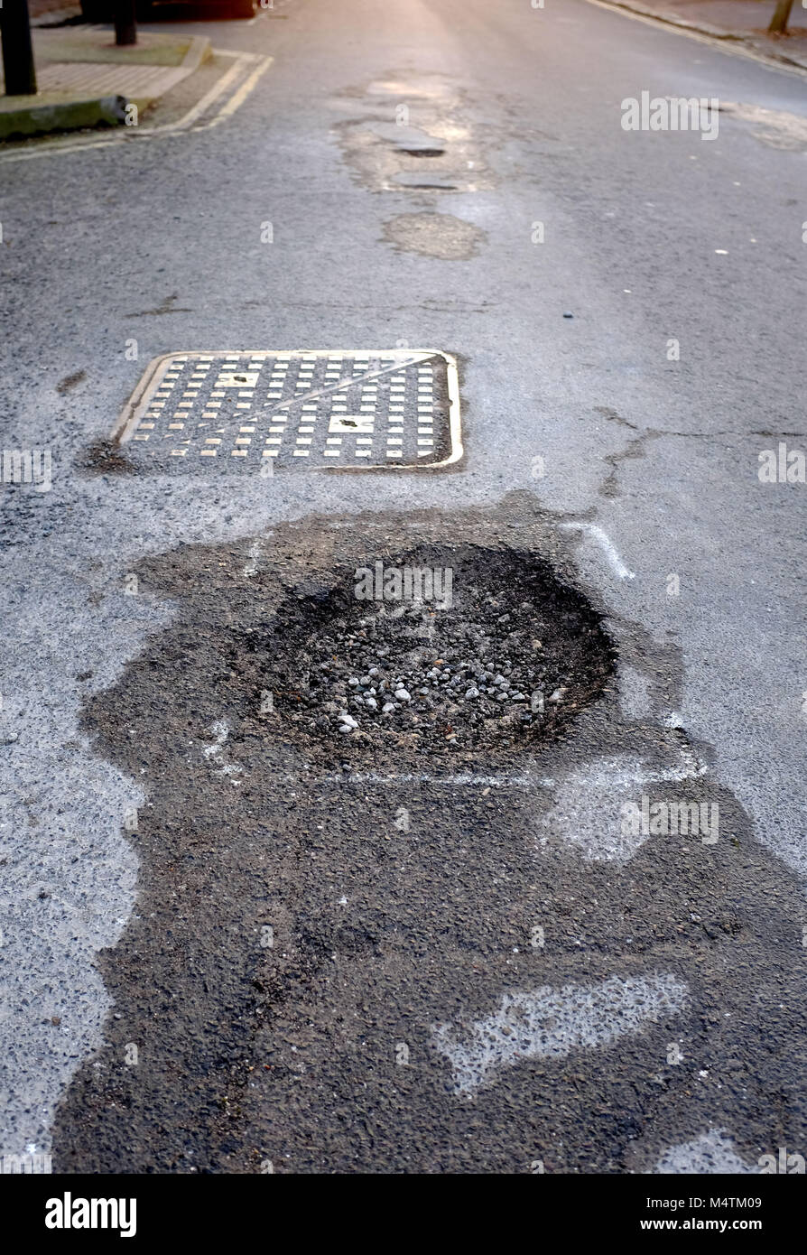 Street Potholes in the Queens Park area of Brighton which have been earmarked for repair by the council Stock Photo