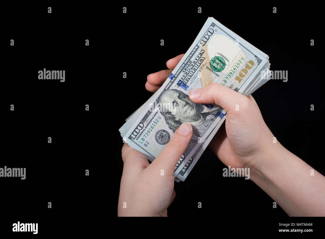 Hand holding American dollar banknotes isolated on white background ...