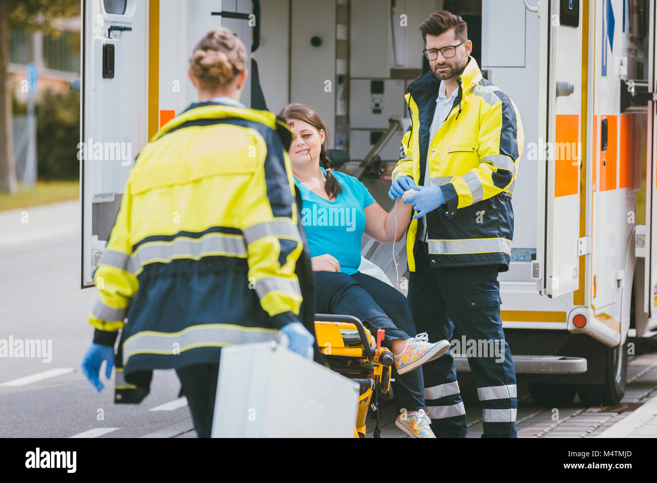 Medic and emergency doctor approaching site of accident Stock Photo
