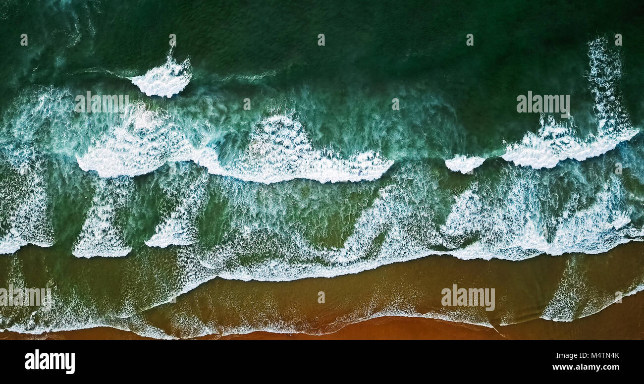 Aerial View From Flying Drone Of Ocean Waves Crushing On Beach Stock Photo