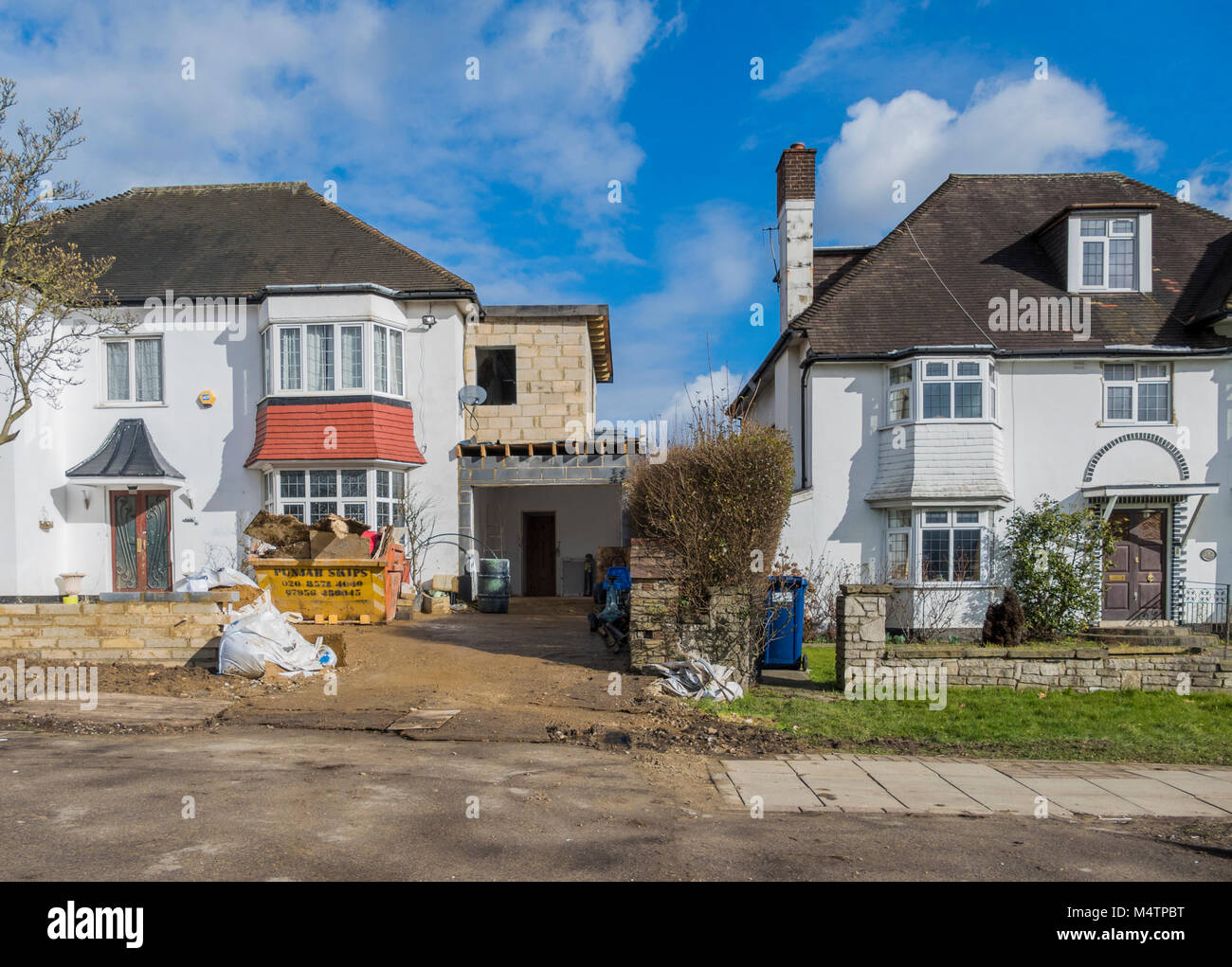 Two storey side extension undergoing construction at a large, period property, on Watford Way - a main road in Hendon, London NW4, England, UK. Stock Photo