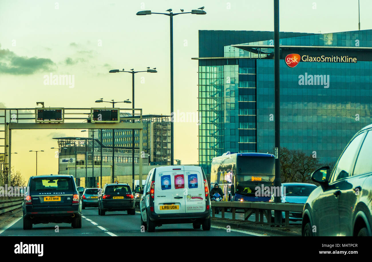 GlaxoSmithKline, global pharmaceuticals company, office block at Brentford, near London. Taken from the busy M4 motorway in traffic, England, UK. Stock Photo