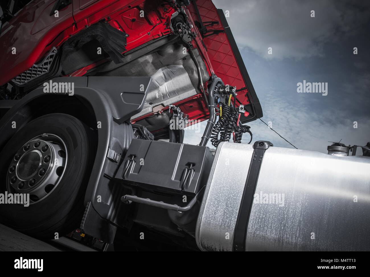 Maintenance of Semi Truck. Modern Euro Truck Tractor Oil and Filters Changing. Heavy Transportation Theme. Stock Photo