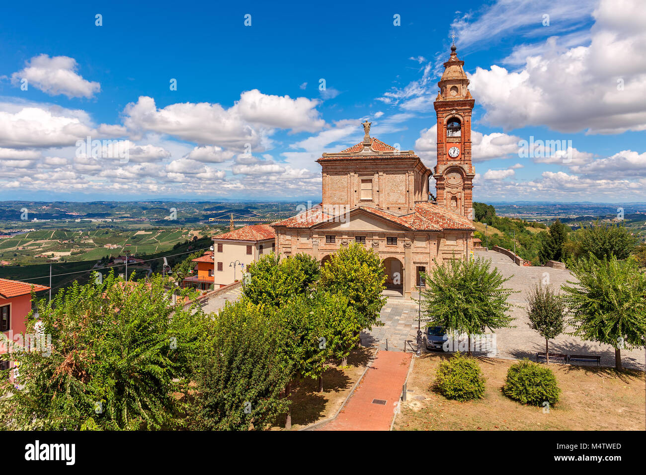 Old catholic church under beautiful blue sky with white clouds in small ...