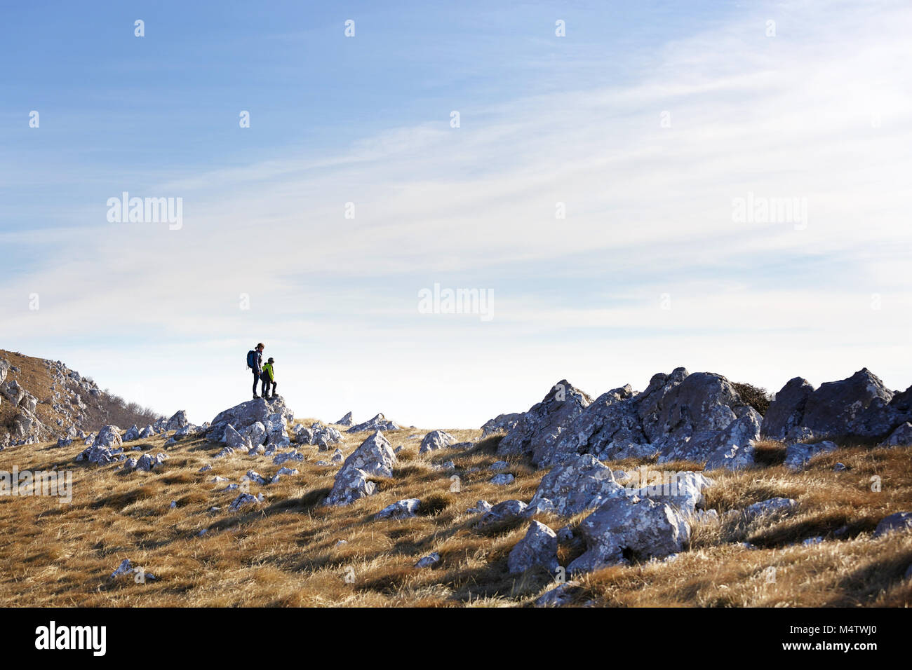 Mother and son standing on the top of the mountain in barren mountain