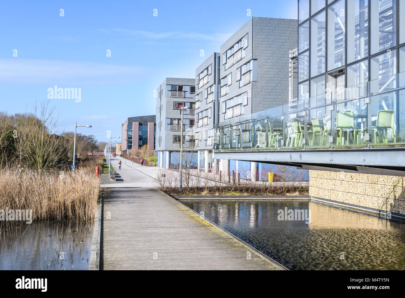 Glass buildings alongside the West Cambridge canal at the west