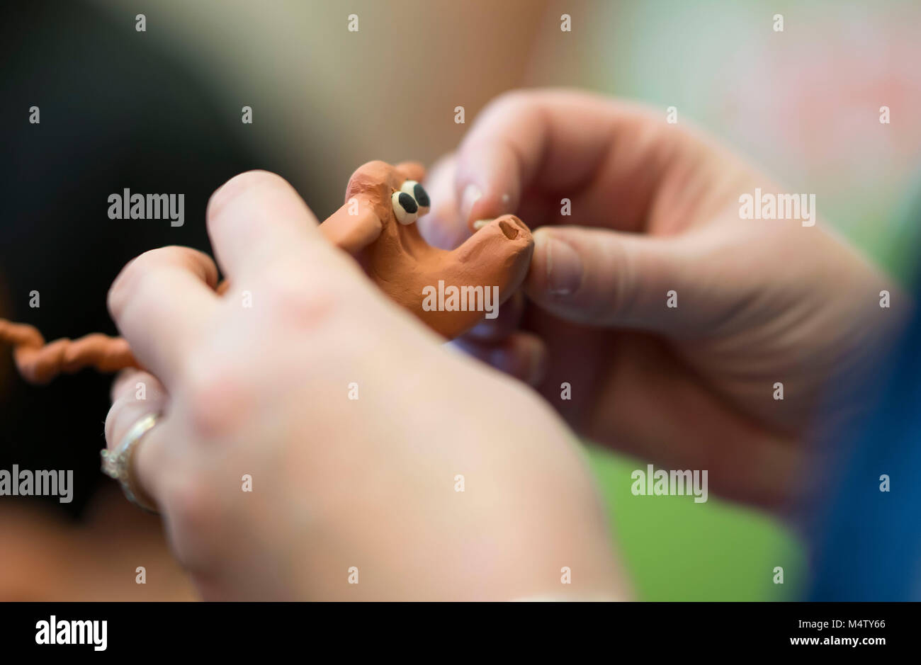 A child making a plasticine model using clay plasticine during a craft workshop. Stock Photo