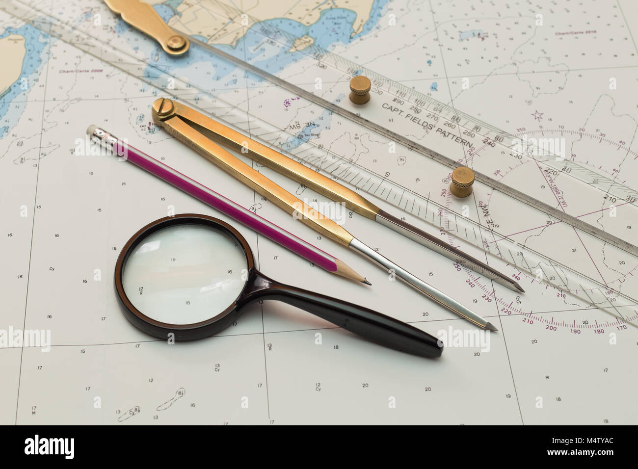 The tool of the navigator for a course lining on sea charts Stock Photo ...