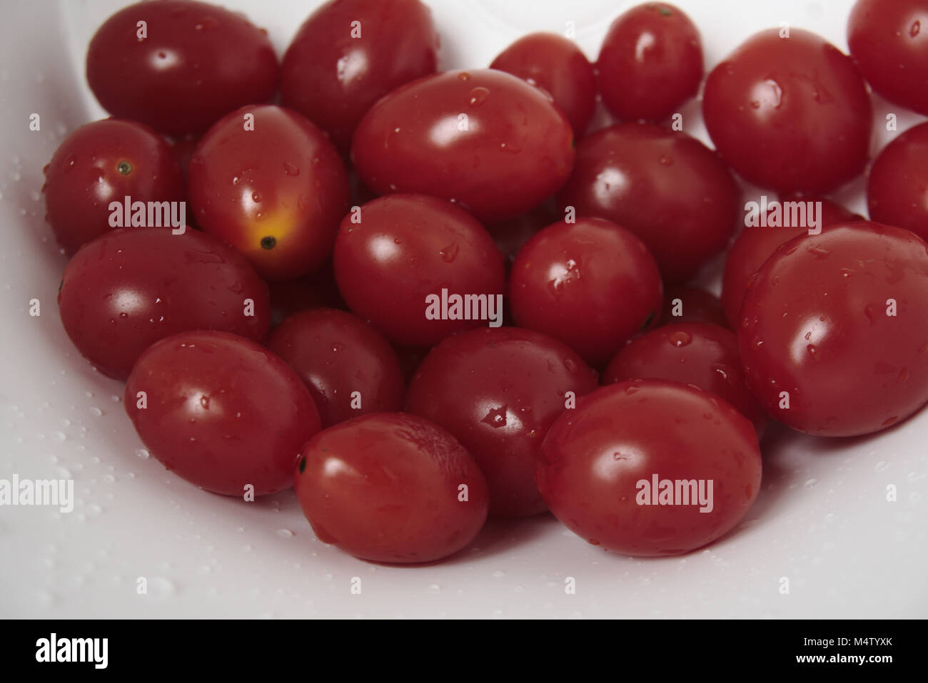 Recently washed cherry tomatoes. Stock Photo