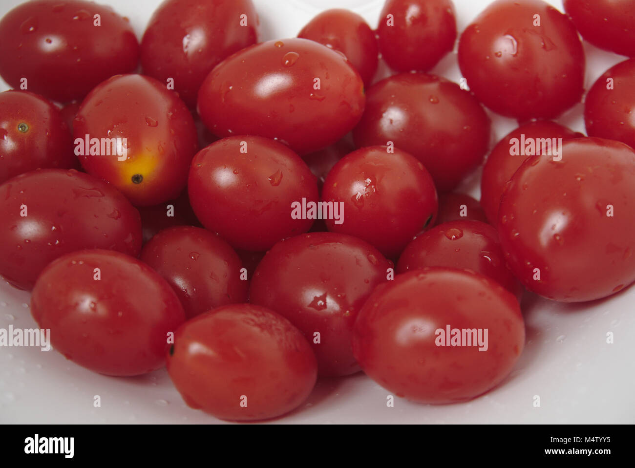 Recently washed cherry tomatoes. Stock Photo