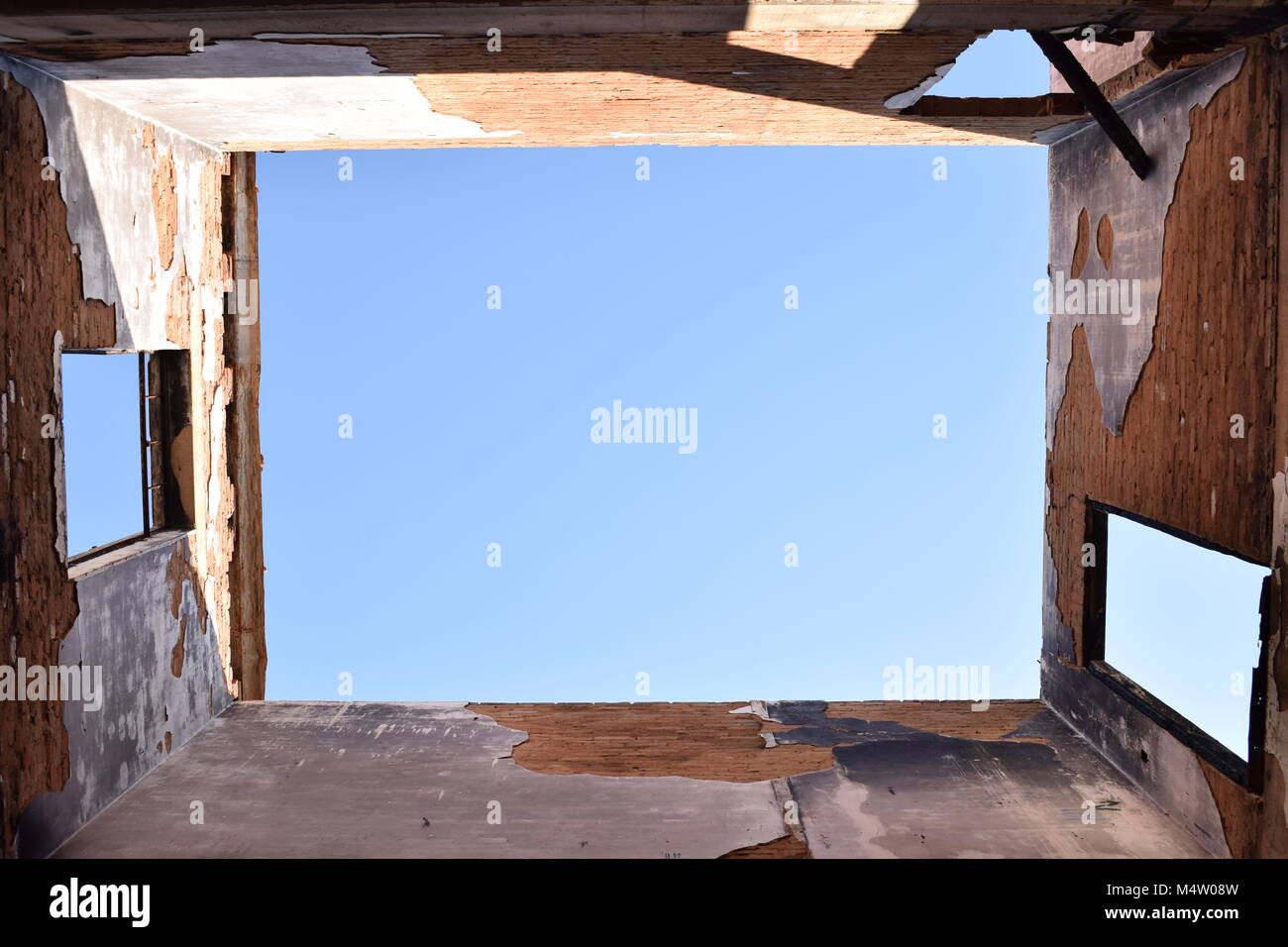 Demolition building blasting the blue sky through windows or the roof ...