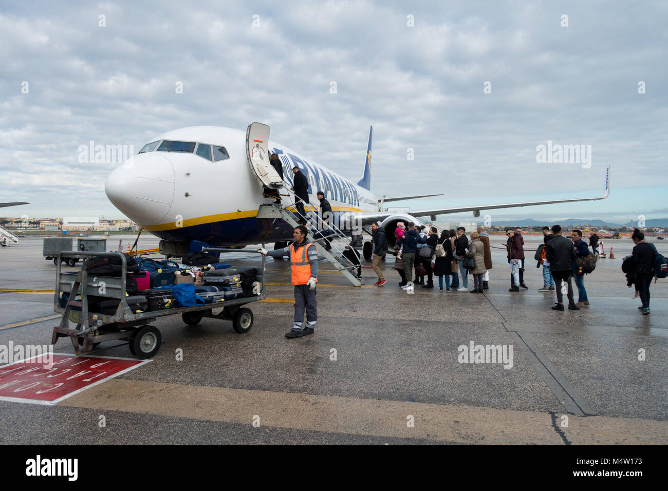 Passengers boarding a Ryanair jet after their new cabin bag policy came into effect - many passenger bags must now be stowed in the aircraft hold Stock Photo