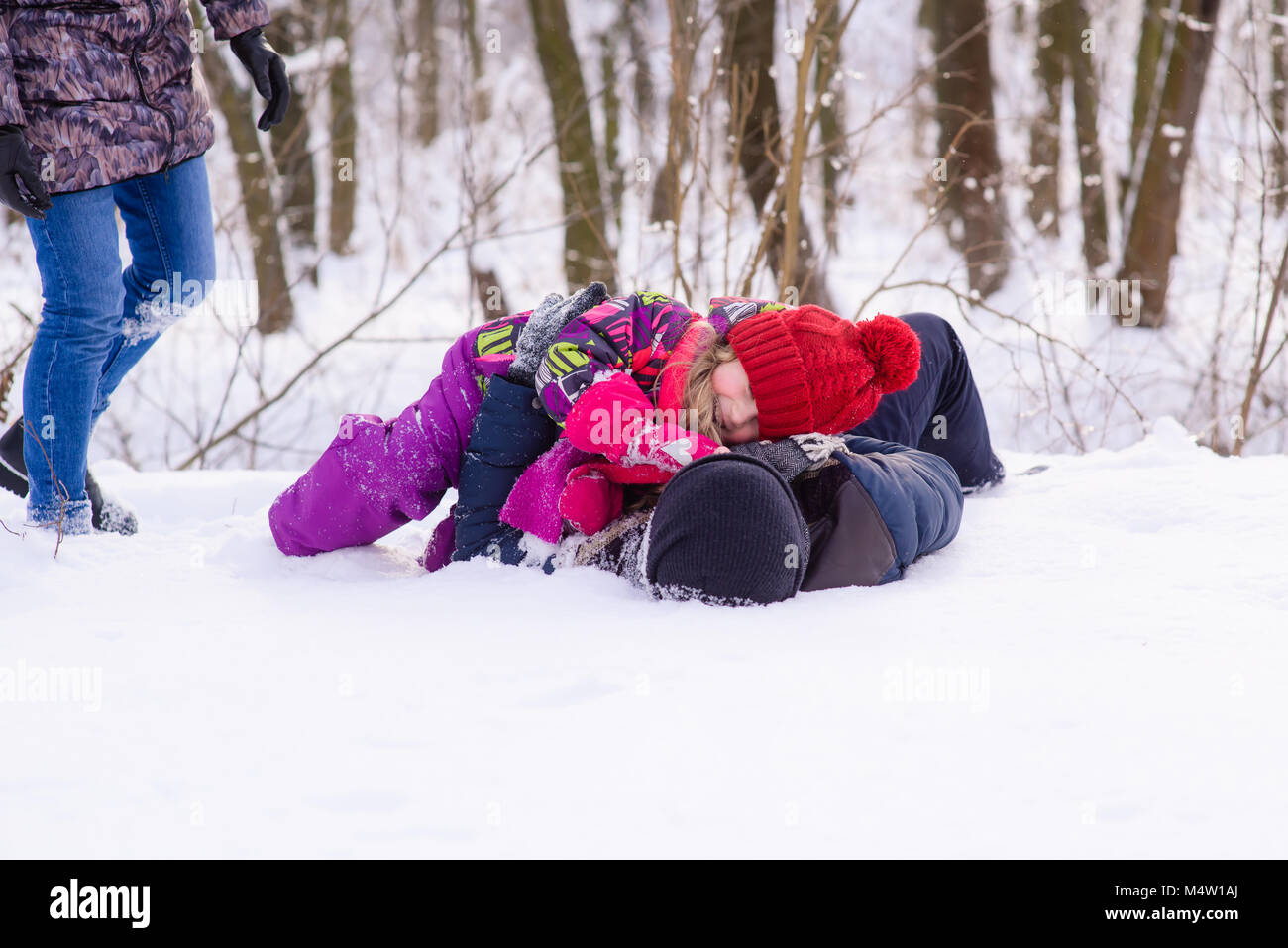 Happy family playing with snow in park Stock Photo - Alamy