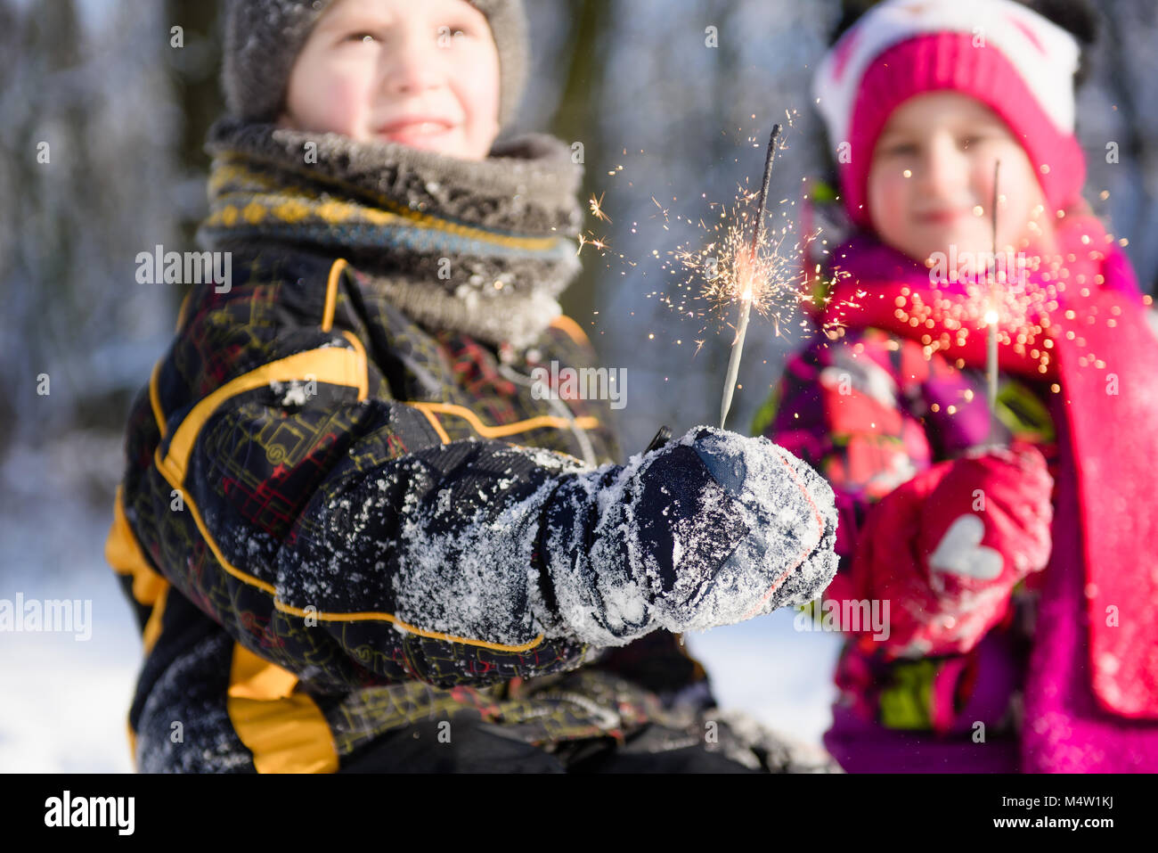 Close-up of bengals in hands of children in winter Stock Photo